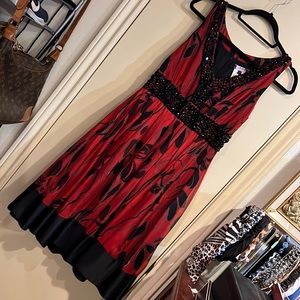 Dark red dress size XS with detailed black stones.